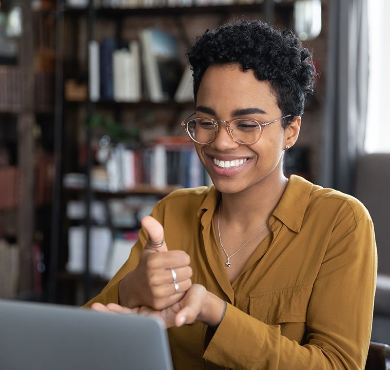 Qualified sign language interpreter signing in a video conference.